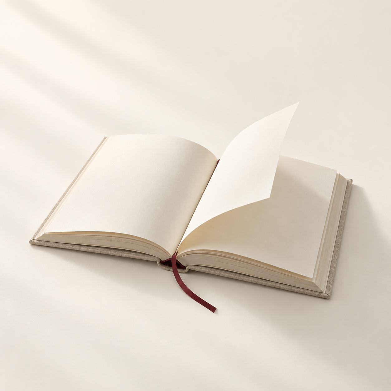 Livro aberto com uma página sendo virada, sobre fundo marfim